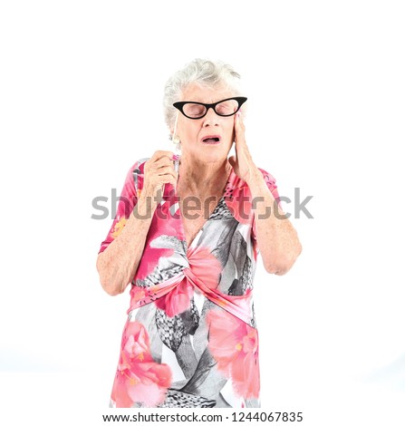 Surprised old woman holding black photo booth glasses against a white background
