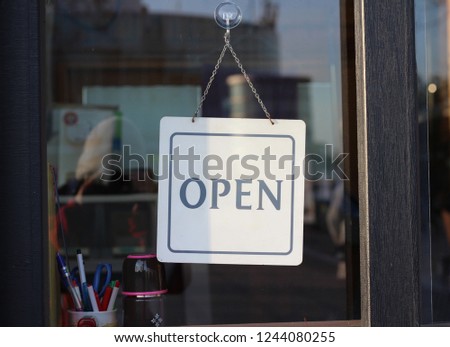 open sign hanging in a shop window