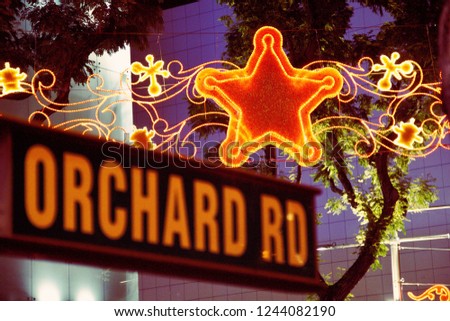 Orchard road sign at street in front of star light