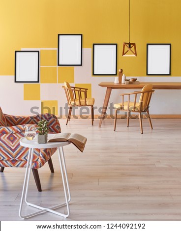 Frame and picture detail on the wall. Yellow background with armchair white coffee table and wooden dinning table style.