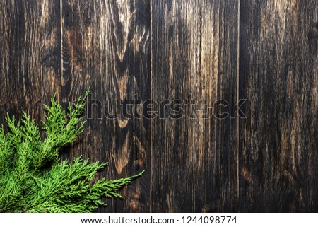Fir branches on a dark vintage wooden background. Christmas concept
