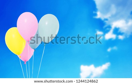 blue,pink,yellow balloons on blurred sky background,copy space, holidays,celebration