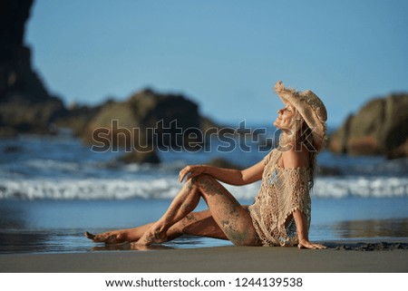 young woman relaxing on the beach in summer day