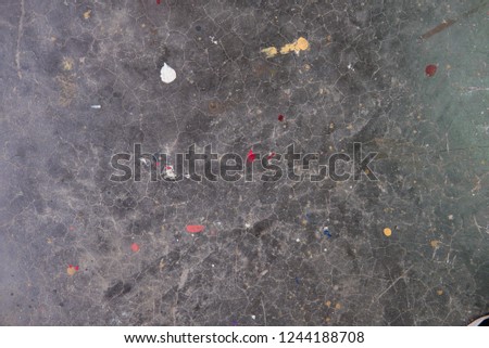 Multi colors paint dot on grey polished floor background.