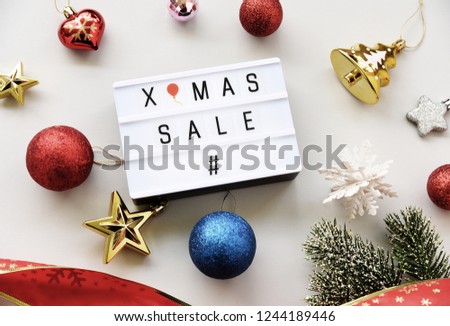 X-MAS SALE text on lightbox composition and Christmas decorations