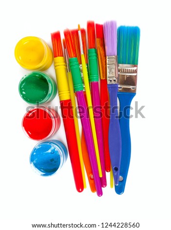 colorful paintbrushes and paint isolated on white