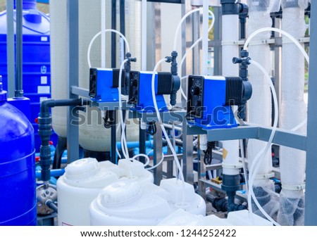 Feed chemicals pump in plant filtration system.  Royalty-Free Stock Photo #1244252422