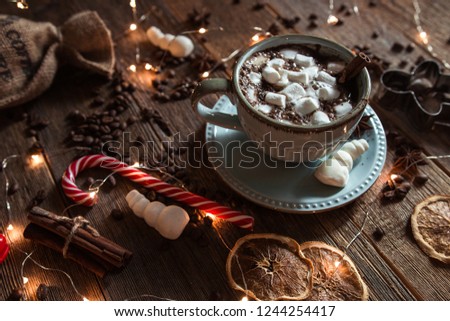 Cup of cocoa and marshmallows on a New Year's background