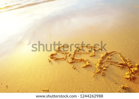 Sea letters handwritten in sand on beach