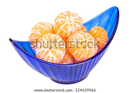 Heap of peeled mandarins in a halfmoonlike blue transparent vase isolated