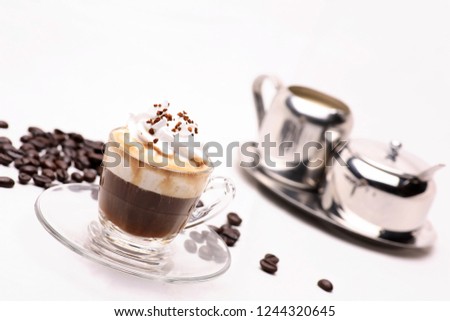 hot Espresso Con Panna coffee in a clear glass on a white background with coffee beans.in studio.