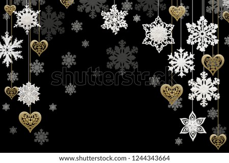 Christmas and New Year decorations: snowflakes and golden hearts on black background. Isolated, black background.