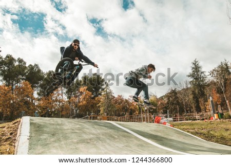 Young skateboarders and bmx bikes. Young people practicing sports in the city