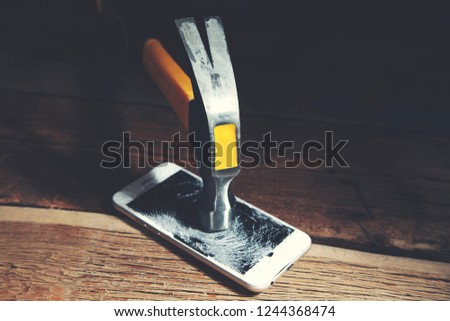 broken phone with hammer