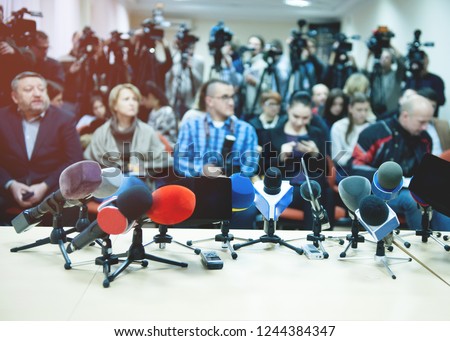 Press conference. News conference with tv. Interview with a video camera. journalist, press and media in public news coverage event for reporter and mass communication. coverage.  Royalty-Free Stock Photo #1244384347