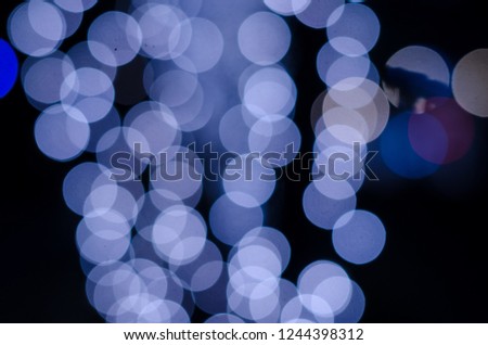Abstract blue soft blurred bokeh on black background. Shining and blurred circles background. For used wallpaper texture and background with copy space area for a text. 