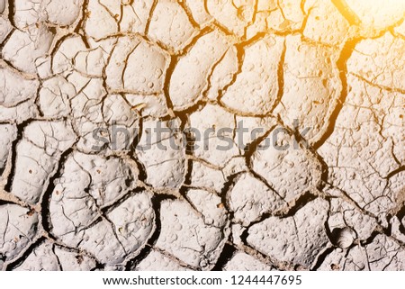 Texture, background of dry cracked earth ground. Global shortage of water on planet. Deep cracks in land as symbol of hot climate and drought. Concept of global warming