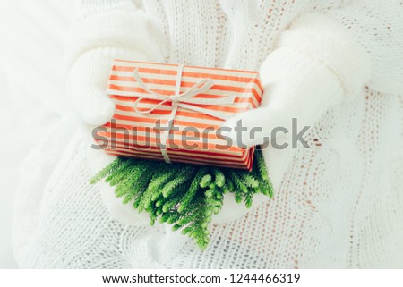 Woman's hands hold christmas or new year gift box.