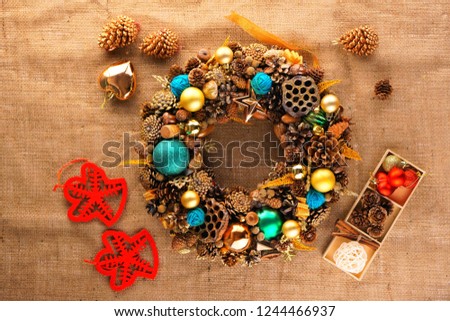 Christmas wreath of cones and toys and Christmas decorations are on the background of coarse cloth or burlap  stock photo
