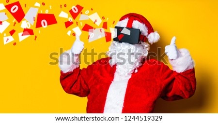 Funny Santa Claus have a joy with VR glasses on yellow background