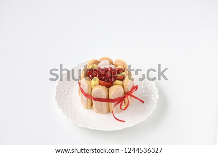 Single portion cake with cream and red currant, tasty cake for breakfast and parties. Bright picture on a white background