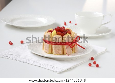 Single portion cake with cream and red currant, tasty cake for breakfast and parties. Bright picture on a white background