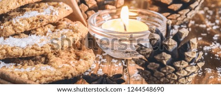 Homemade oatmeal cookies, cinnamon and anise seeds. baking on a wooden rustic table, served with winter accessories. Winter holiday still life Christmas or New Year card