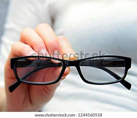 woman holding glasses on display with white background stock photo