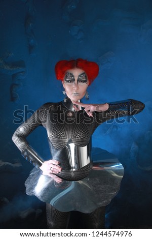 Pretty RedHaired Futuristic Girl With FaceArt Make-Up Wearing Spandex Catsuit and Steel Corset