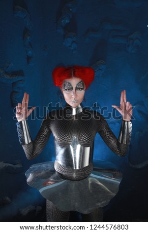 Alien Futurisctic Woman With Red Hair And Steel Costume On Dark Background