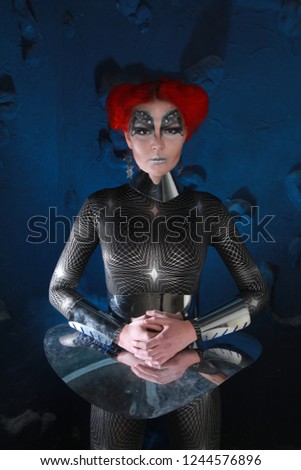 Alien Futurisctic Woman With Red Hair And Steel Costume On Dark Background