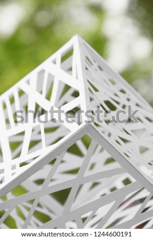 Macro image of paper folded in geometric shapes, three-dimensional effect, abstract background. Out of focus.