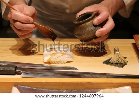 Japanese Chef Making Sushi-Tokyo-Japan Royalty-Free Stock Photo #1244607964