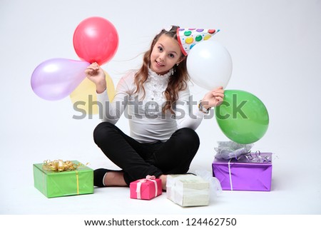 Girl, gifts and balloons.