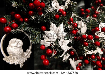 Close up of silver maple leaf and owl Christmas wreath decorations