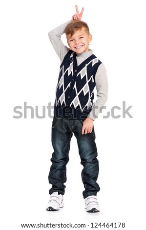 Full length portrait of a happy boy keeping two fingers above head isolated on white background