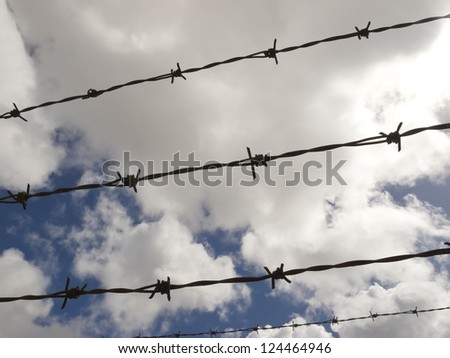 Barbed wire with a cloudy sky background