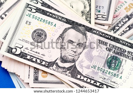 Close-up portrait of President Lincoln on a new five-dollar bill.