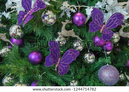 Beautiful decorated Christmas tree theme silver and purple on blurred, sparkling background