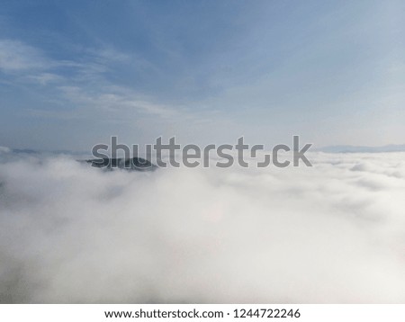 Landscape of Morning Mist with Mountain Layer at  north of Thailand. Aerial View. Flying over the high mountains in beautiful clouds . Aerial camera shot.