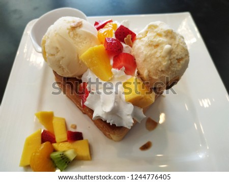 Ice cream mixed fruit in white dish on black background