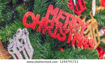 Red Merry Christmas on green Christmas tree
