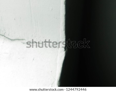 wall crack and black background  Royalty-Free Stock Photo #1244792446