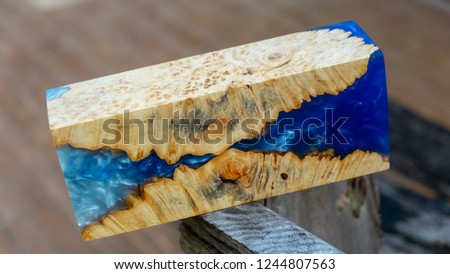 casting epoxy resin Stabilizing Afzelia burl exotic wood blue background, Abstract art picture photo, print design and your advertisement, hybrid