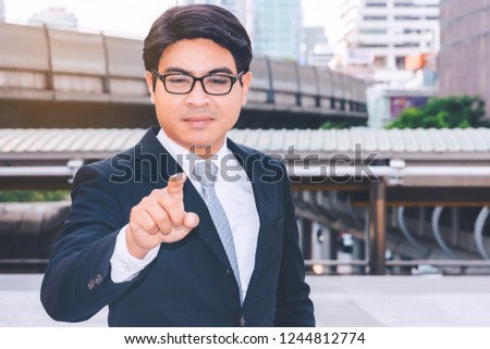 Portrait of a young successful businessman standing in city