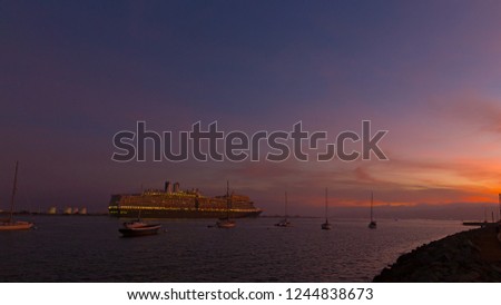 San Diego harbor panorama at night, California USA. Water transportation at harbor with boats, cruise ship and yachts.
