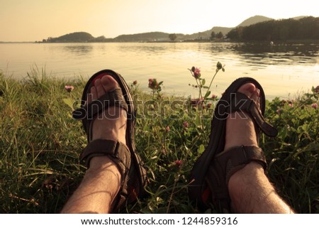 Relaxing on the grassy beach by the lake