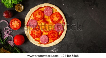 pizza, dough, ingredients, pepperoni, cheese, toatny sauce (cooking process). Top view with copy space