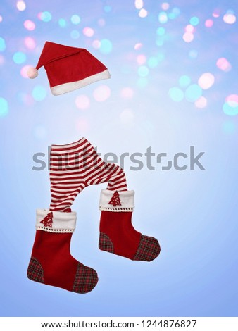 Christmas clothes and attributes forming a little walking elf on blue snowy background, winter holiday symbol, Christmas and new year sales
