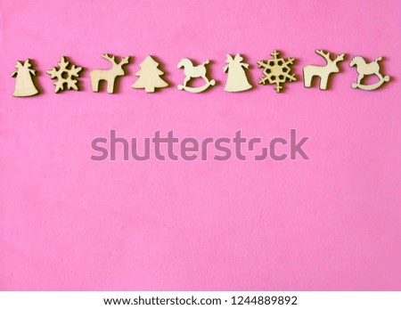 Decorative Christmas and New Year background with wooden figures of traditional decor. Horses, deer, snowflakes, fir trees. Festive template. Greeting card with copy space.